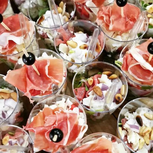 Meloenmix met rucola, pecorino en Italiaanse ham.